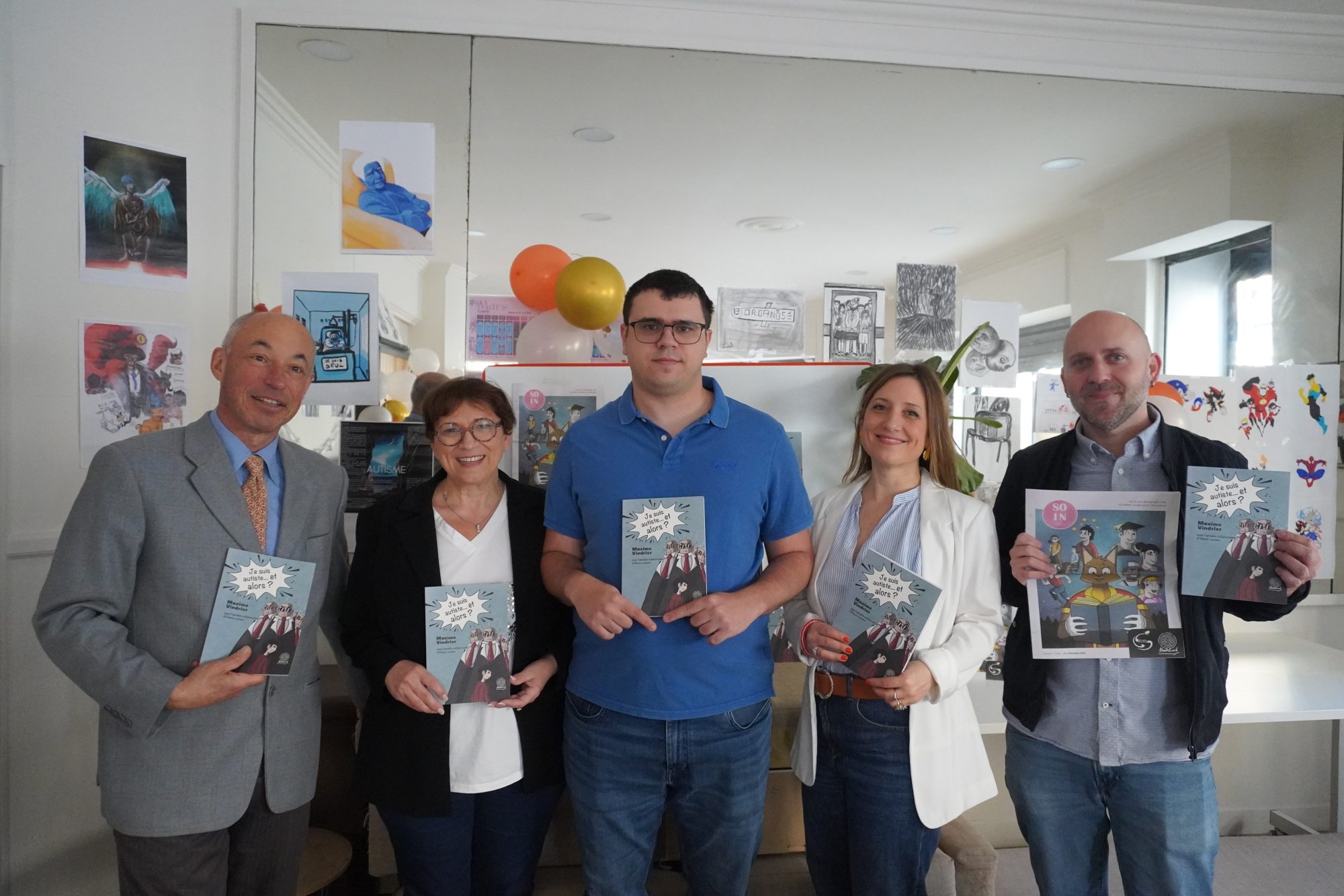 People are holding a book and smiling
